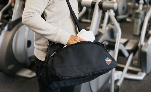 Person carrying the OSCA in a gym with an optional shoulder strap.